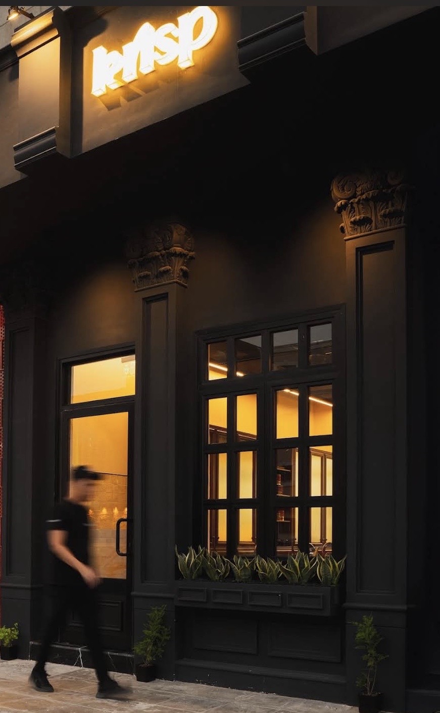 The KRISP storefront in Riyadh, neon sign glowing above black-painted windows